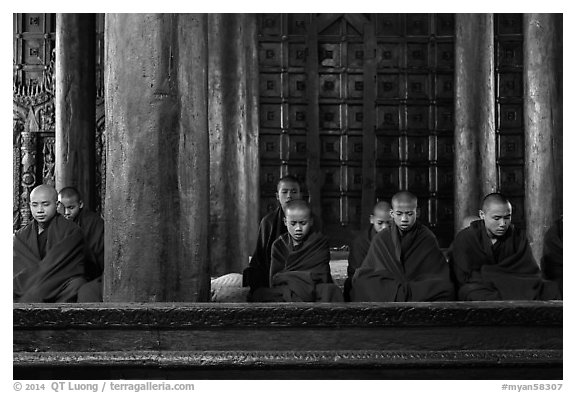 Monks during evening prayer. Mandalay, Myanmar (black and white)