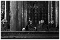 Monks during evening prayer. Mandalay, Myanmar ( black and white)