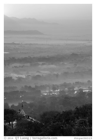 Fog shrouded plain below Mandalay Hill at sunrise. Mandalay, Myanmar (black and white)