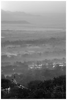 Fog shrouded plain below Mandalay Hill at sunrise. Mandalay, Myanmar ( black and white)