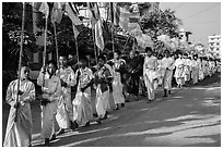 Children carry Buddhist flags ahead of alms procession. Mandalay, Myanmar ( black and white)