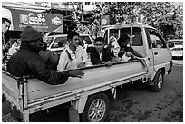 Families riding on back of pick-up truck. Mandalay, Myanmar ( black and white)