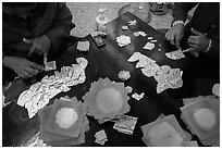 Gossamer-thin pieces of gold cut in squares, gold leaf workshop. Mandalay, Myanmar ( black and white)