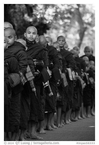 Monks lining up with alms bowls, Mahagandayon Monastery. Amarapura, Myanmar (black and white)