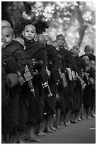 Monks lining up with alms bowls, Mahagandayon Monastery. Amarapura, Myanmar ( black and white)
