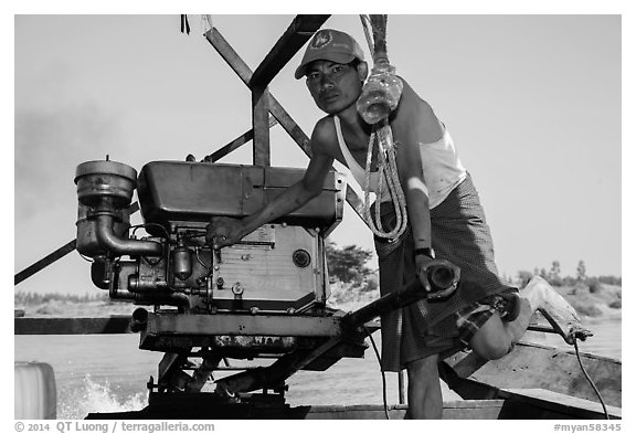 Boatman with one cylinder engine, Ava. Myanmar (black and white)