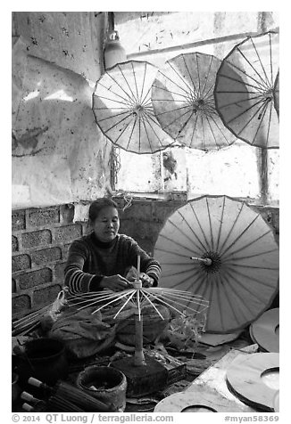 Woman assembling the paper umbrellas carried by the monks. Pindaya, Myanmar (black and white)