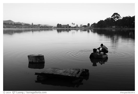 Woman washing laundry in Pone Tanoke Lake at dawn. Pindaya, Myanmar (black and white)