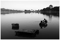 Woman washing laundry in Pone Tanoke Lake at dawn. Pindaya, Myanmar ( black and white)