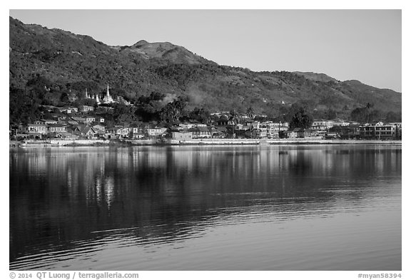Hill and town reflected in Pone Tanoke Lake at sunrise. Pindaya, Myanmar (black and white)