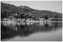 Hill and town reflected in Pone Tanoke Lake at sunrise. Pindaya, Myanmar ( black and white)