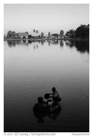 Woman washing laundry in Pone Tanoke Lake at sunrise. Pindaya, Myanmar (black and white)