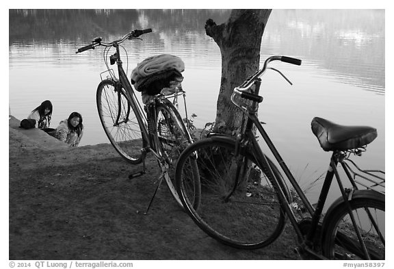 Bicycles and women doing laundry in Pone Tanoke Lake. Pindaya, Myanmar (black and white)