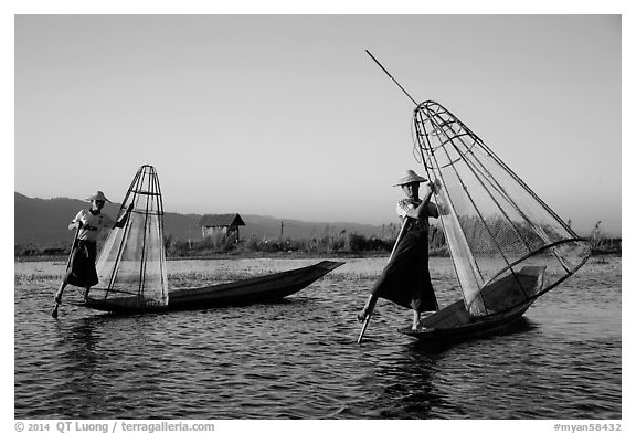 Intha fishermen row with leg and hold conical baskets. Inle Lake, Myanmar (black and white)