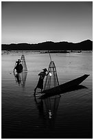 Intha fishermen carrying lanterns at dusk. Inle Lake, Myanmar ( black and white)