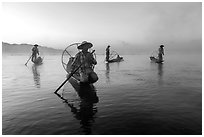 Group of Intha fishermen at dawn with surface mist. Inle Lake, Myanmar ( black and white)