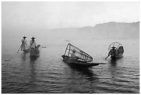 Group of Intha fishermen on misty waters. Inle Lake, Myanmar ( black and white)