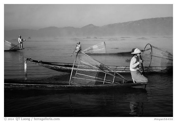 Intha fishermen with conical baskets in morning mist. Inle Lake, Myanmar (black and white)