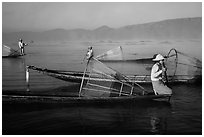 Intha fishermen with conical baskets in morning mist. Inle Lake, Myanmar ( black and white)