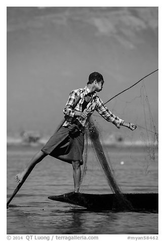 Intha fisherman gathering net. Inle Lake, Myanmar (black and white)