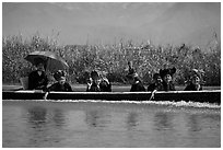 Women with turbans on long tail boat. Inle Lake, Myanmar ( black and white)