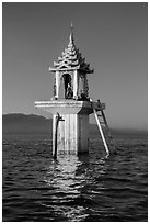 Water level marker topped by shrine. Inle Lake, Myanmar ( black and white)