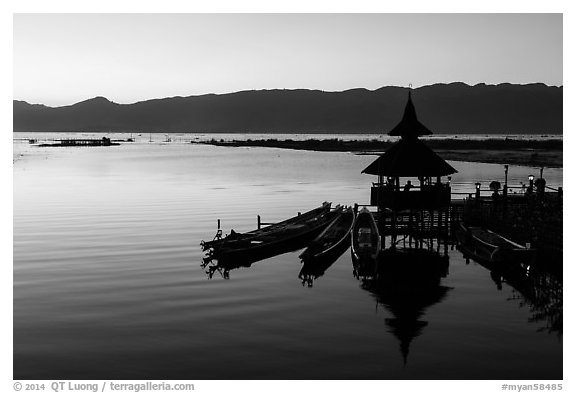 Deck, pavillion, and longtail boats at sunset. Inle Lake, Myanmar (black and white)