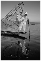 Intha fisherman with freshly caught fish in basket. Inle Lake, Myanmar ( black and white)