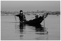 Fisherman retrieves net. Inle Lake, Myanmar ( black and white)