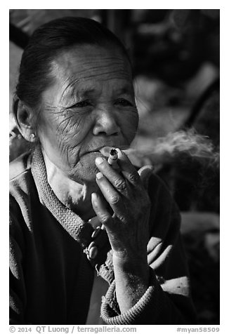 Woman smoking cheerot cigar. Inle Lake, Myanmar (black and white)