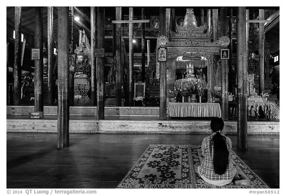 Woman praying at Nga Phe Kyaung monastery. Inle Lake, Myanmar (black and white)