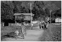 Villagers walking on path to jetty, Maing Thauk Village. Inle Lake, Myanmar ( black and white)