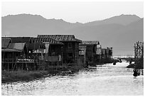 Houses and canal at sunset, Maing Thauk Village. Inle Lake, Myanmar ( black and white)