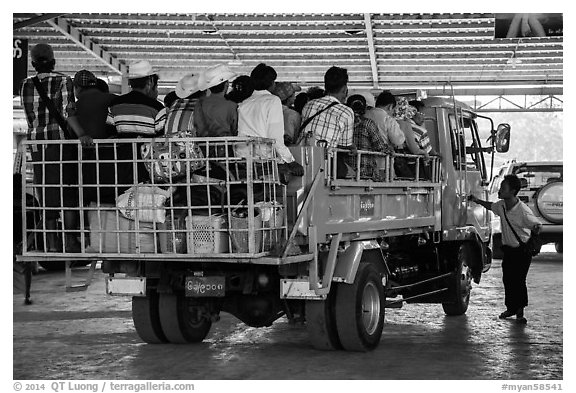 Bus leaving base station with 35 passengers in the back. Kyaiktiyo, Myanmar (black and white)
