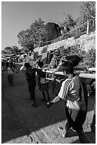 Vistor carried by porters on sedan chair,. Kyaiktiyo, Myanmar ( black and white)