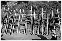 Child walking past sedan chairs. Kyaiktiyo, Myanmar ( black and white)