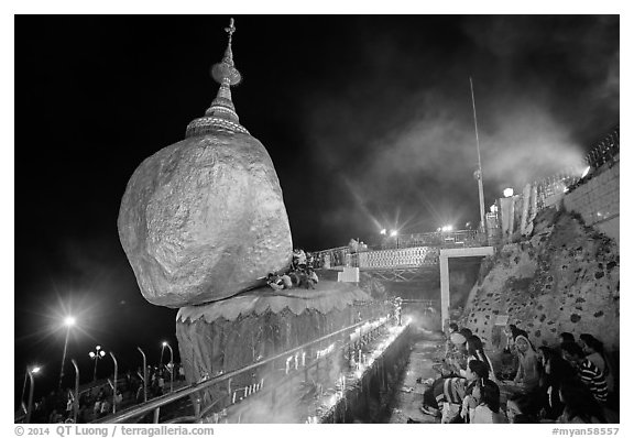 Pilgrims pray next to the Golden Rock. Kyaiktiyo, Myanmar (black and white)