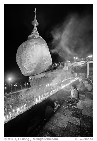 Offerings to the Buddha continues throughout the night at the Golden Rock. Kyaiktiyo, Myanmar (black and white)