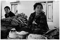 Women at street food stalls, Potemkin village. Kyaiktiyo, Myanmar ( black and white)