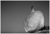 Golden Rock balancing boulder stupa and monks at dawn. Kyaiktiyo, Myanmar ( black and white)