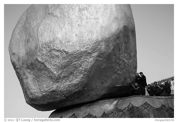 Monks kneeling in prayer at the Golden Rock. Kyaiktiyo, Myanmar (black and white)