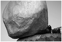 Monks kneeling in prayer at the Golden Rock. Kyaiktiyo, Myanmar ( black and white)