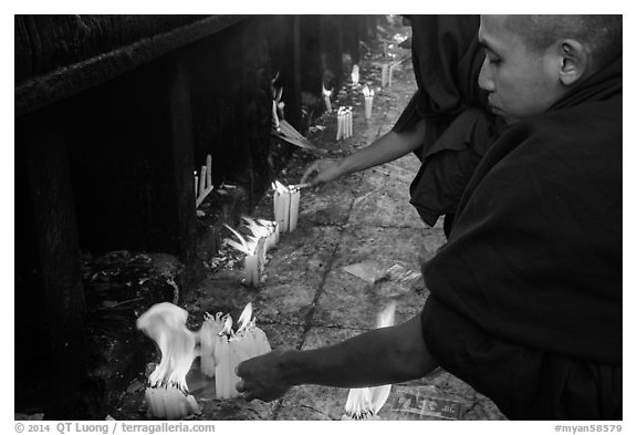 Monks lighting candles. Kyaiktiyo, Myanmar (black and white)