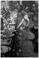 Morning food offering and pilgrims with cold weather hats. Kyaiktiyo, Myanmar ( black and white)