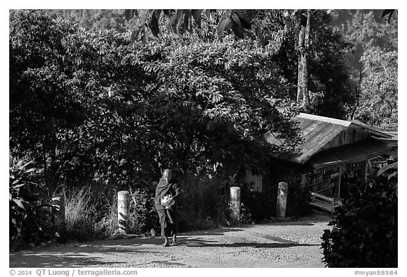 Monk walking barefoot on the path to the Golden Rock. Kyaiktiyo, Myanmar (black and white)