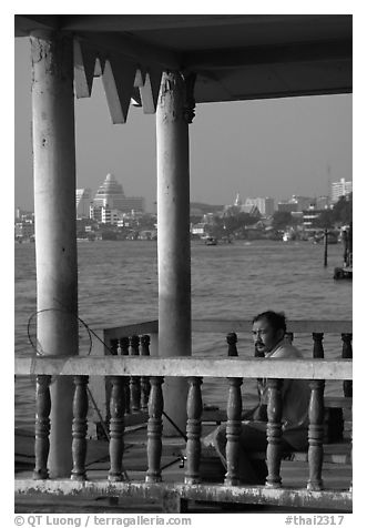 Man fishing on the Chao Phraya river. Bangkok, Thailand (black and white)