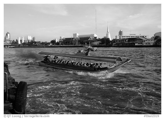Crowded long tail taxi boat on Chao Phraya river. Bangkok, Thailand (black and white)