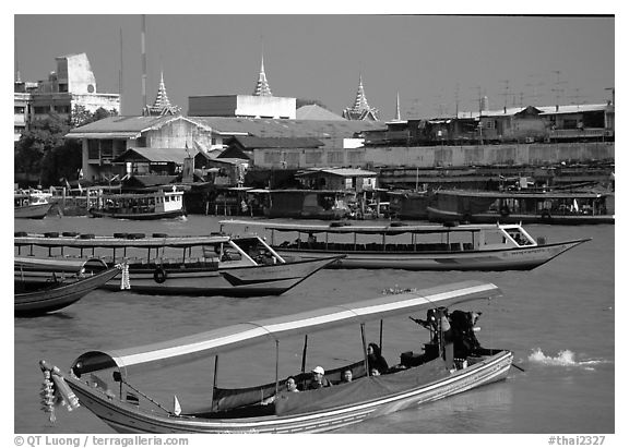 Flotilla of boats on the Chao Phraya river. Bangkok, Thailand (black and white)
