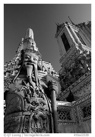 Statue and tower, Wat Arun. Bangkok, Thailand