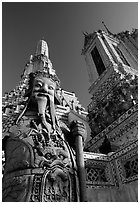 Statue and tower, Wat Arun. Bangkok, Thailand (black and white)